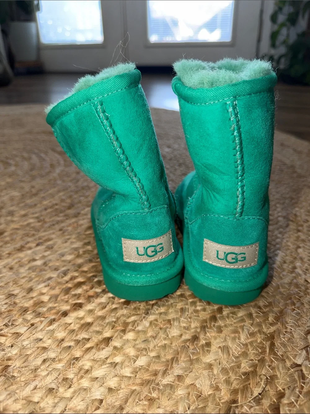 UGG Kids' Classic Short II boots in a  emerald green genuine shearling lining.